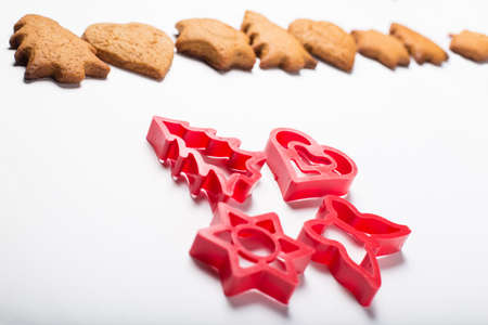 Forms for gingerbread cookies and cookies on a white backgroundの写真素材
