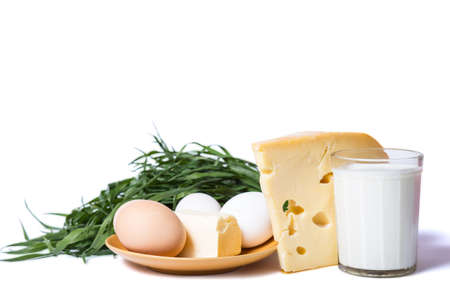 Butter, eggs, cheese and milk with bunch of grass isolated on a whiteの写真素材