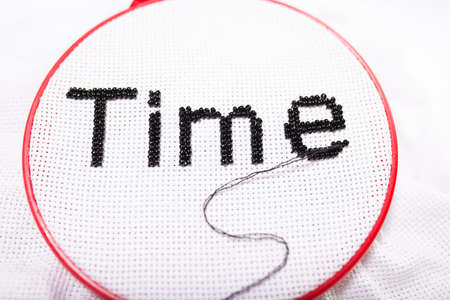 The concept of the concept of time, the word "time" is embroidered with a thread and beadsの写真素材