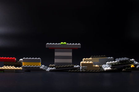 Spare parts of the children's constructor, scattered on a black background.