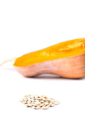 Pumpkin seeds with half of pumpkin on background, isoalted on a white.の写真素材