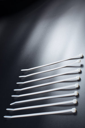 White cable ties on black background with copy space.