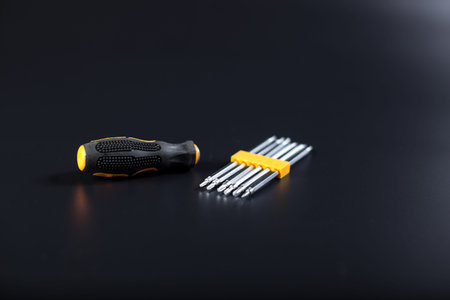 Set of little screwdrivers for small elecrtonics repair, on black background.