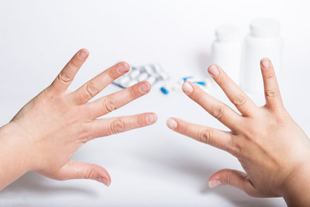 Female hands refuse pills and drugs, on a white background.