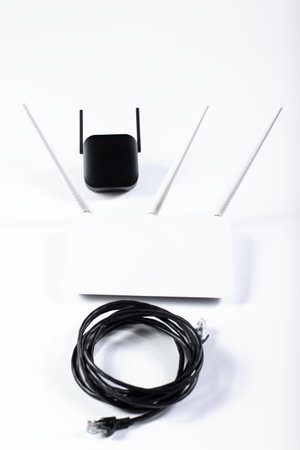 White wifi router and amplifier with cable on a white background.の写真素材