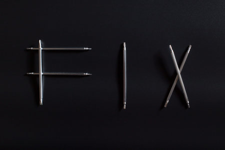 Word FIX made of little screwdrivers for fixing smartphones and other electronic, on black...
