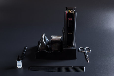 Set of shaving machine with attachments and other tools for barber on a black background.の写真素材