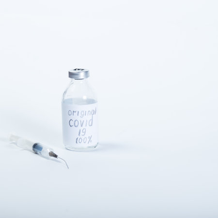 Fake vaccine in glass medical container and bad syringe on a white background with copy space.の写真素材