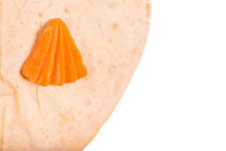 Orange lavash cloredr with carrot on a white background and with copy space.の写真素材