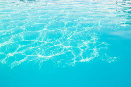 Background of clear blue beautiful water in swimming pool.