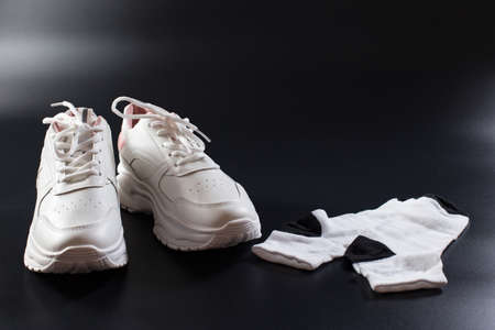 White sneakers with socks prepared on black backgroud for females training.の写真素材