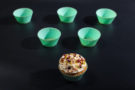 Silicone mint color molds for cup cake baking on black background.