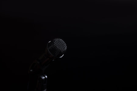 Black microphone close up on black bakcxground with copy space.の写真素材