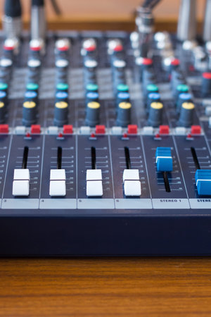 Closeup mixer in recording room. Closeup button to increase or decrease sound