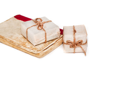 Gift books beautifully wrapped and bandaged with ribbon bow on a white backgroundの写真素材