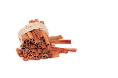 cinnamon sticks bandaged with rope on white backgroundの写真素材