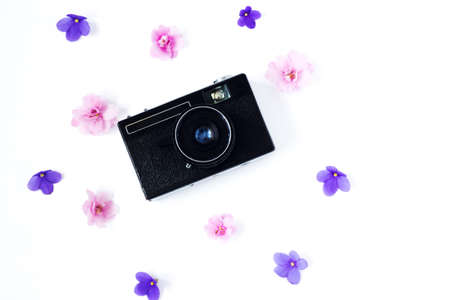 Pink and lolac flowers with retro camera. old school concept on white background. Top viewの写真素材