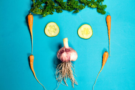 Vegetable funny face. Fresh organic Vegetables on Wooden table. Healthy Vegetarian food, View from above.の写真素材
