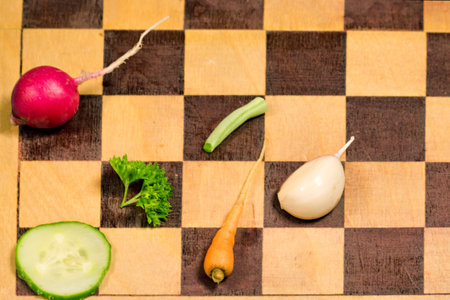 Fresh slice vegetables on the cutting chess board.