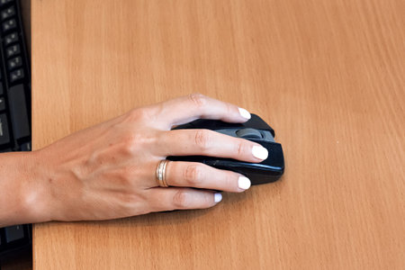 Closeup of hand using computer mouse