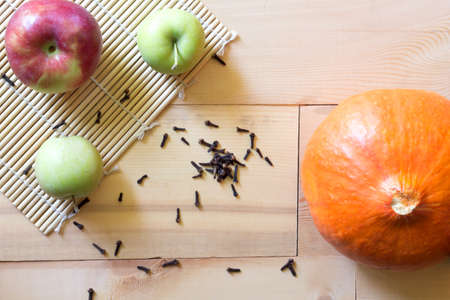 Wood background with pumpkin, apples and Carnationの写真素材