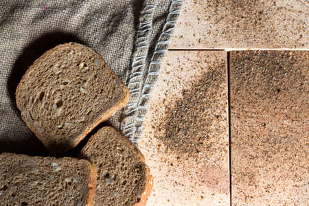 Top view of sliced wholegrain bread on a wooden table.の写真素材