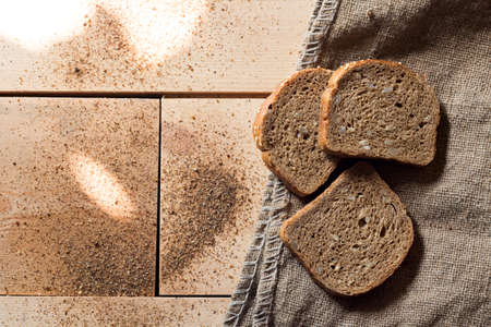 sliced bread on wooden table with rolling pinの写真素材