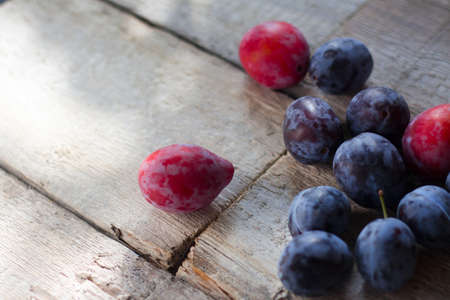 Plums on a rustic wooden tableの写真素材
