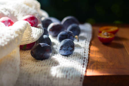 Fresh plums On wooden background.の写真素材
