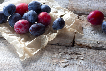 Fresh plum fruit on rustic white woodの写真素材