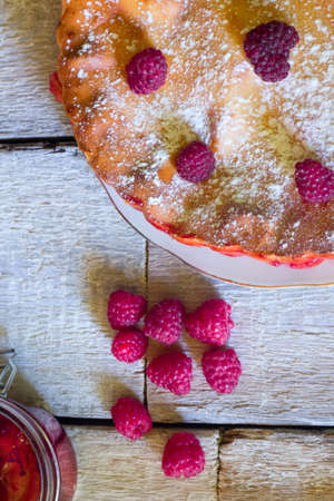 Raspberry pie with fresh raspberries and jam on white wooden background. Top viewの写真素材