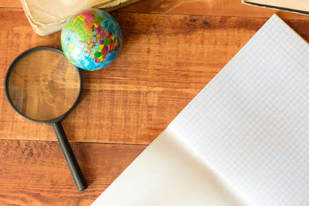 School supplies with book, note paper, Magnifier notepad on wooden table with copyspace for your text, design. Back to school conceptの写真素材