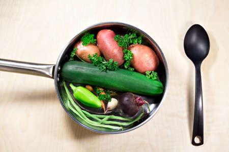 Fresh vegetables and frying pan to cook on wood backgroundの写真素材