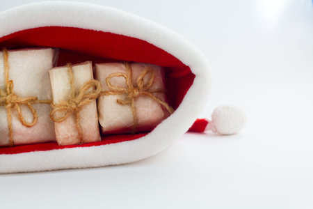 Christmas gift box and santa hat on white backgroundの写真素材