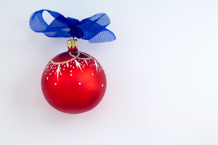 christmas ball with blue ribbon on white backgroundの写真素材