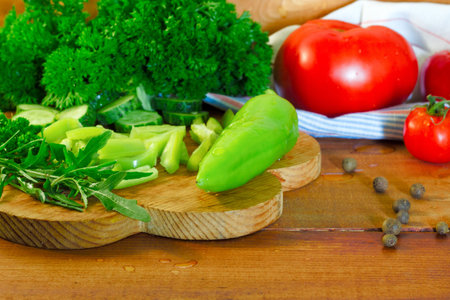 Fresh tomatoes and peppers on a wooden tableの写真素材