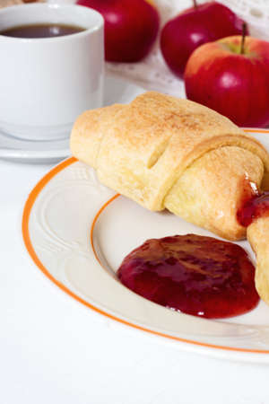 French Breakfast - croissant, jam, honey, apple and coffee on wooden backgroundの写真素材