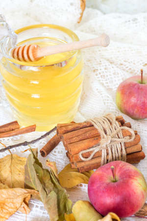 Honey and apples and cinnamon on wooden tableの写真素材