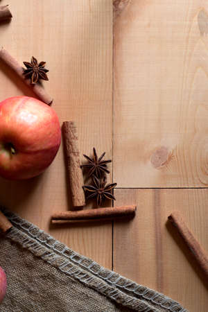 Apples with spices: cinnamon, star anise on a wooden backgroundの写真素材