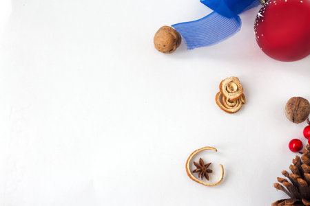 Christmas background. red balls, pine cones and berries on white background. copy space. Vertical.