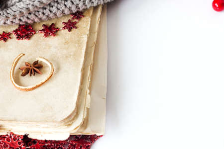 Old cooking book on white background with anise and red garlandの写真素材