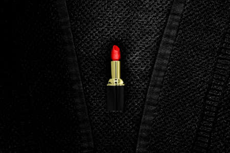 red pomade lies on a black terry clothの写真素材