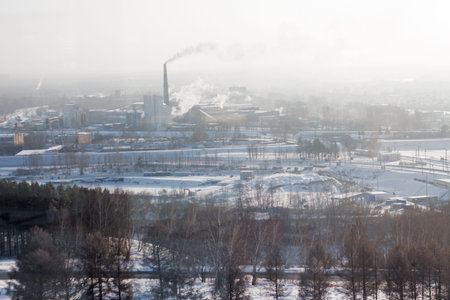 Winter cityscape. Trees, wood, track, snow, industrial pipes.の写真素材