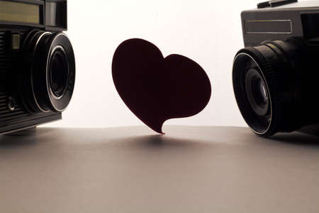 Love heart and cameras . Love photo or oter love aim concept on white backgroundの写真素材