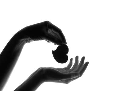 love heart in young woman hands on a bright white background. Love concept, save love, accept loveの写真素材