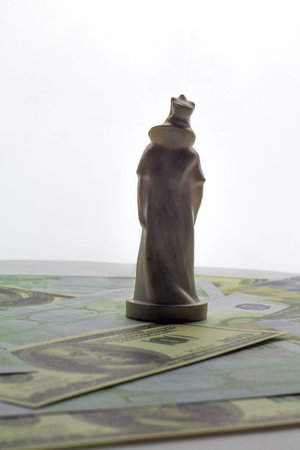 chess white queen on money banknote background. worship or money or business concept