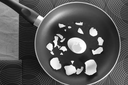 Breakfast of bachelor or diet food . Egg and shell in frying pan .の写真素材