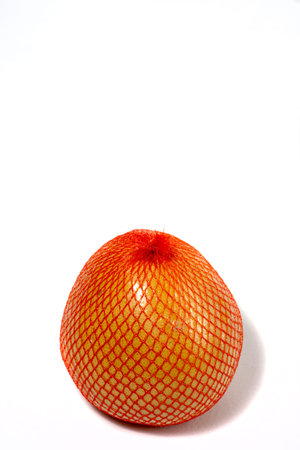 A ripe pomelo is packaged in a grid. Pomelo isolated on a white background. Citrus maxima or Citrus...