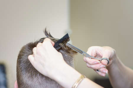 Men's hairstyling and haircutting in a barber shop or hair salon.の写真素材