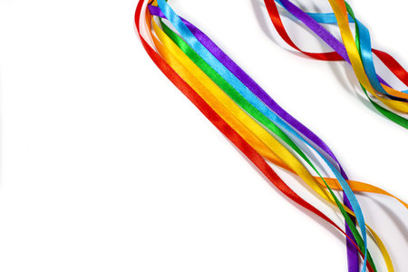 LGBT rainbow ribbon isolated on yellow background, copy space, top view, flat layout